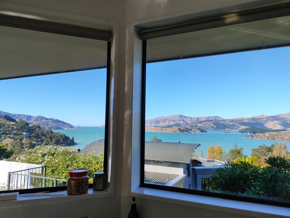 Canterbury harbour and hills view through a home window - Kim's local patch