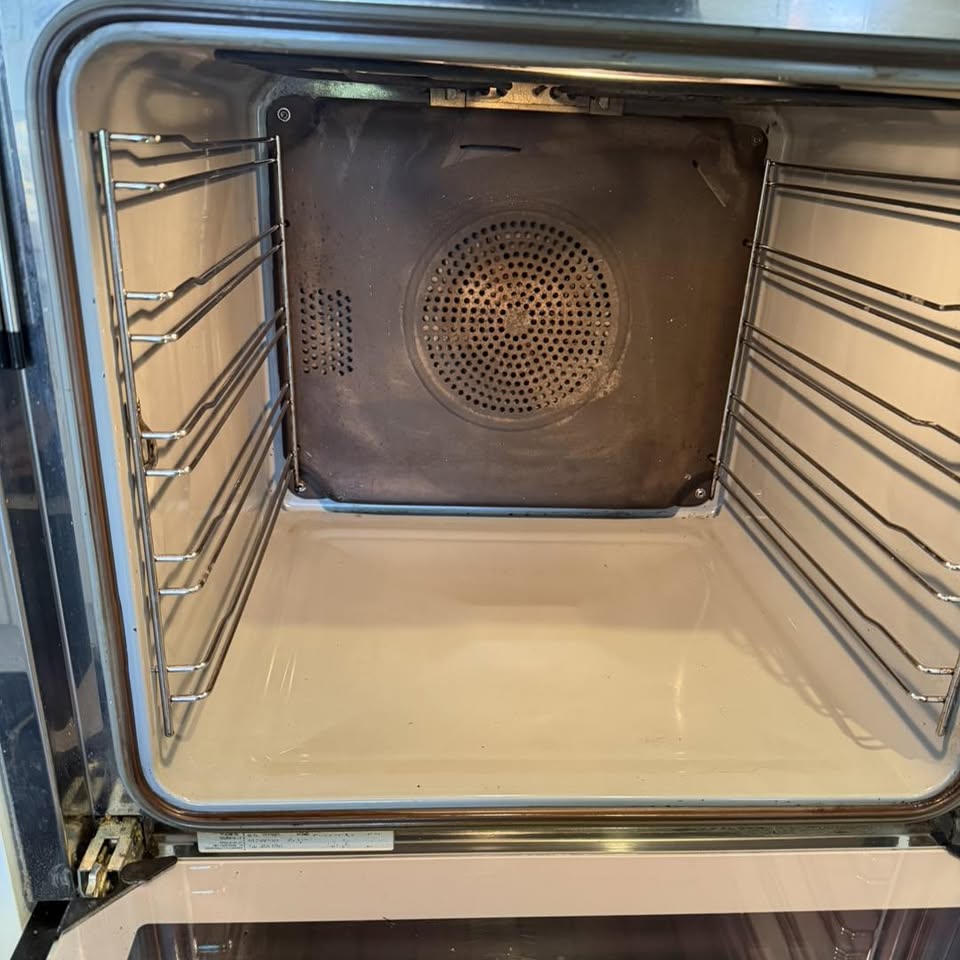 Same oven cavity gleaming clean with white enamel interior after Kim's eco clean